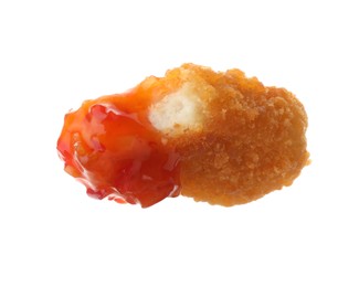 Photo of Tasty nugget dipped in hot chili sauce isolated on white