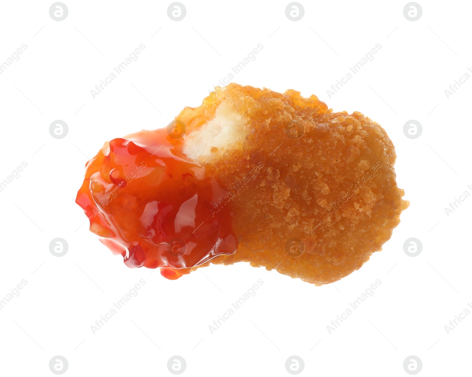 Photo of Tasty nugget dipped in hot chili sauce isolated on white