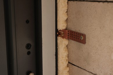 Photo of One copper hinge on newly installed door, closeup