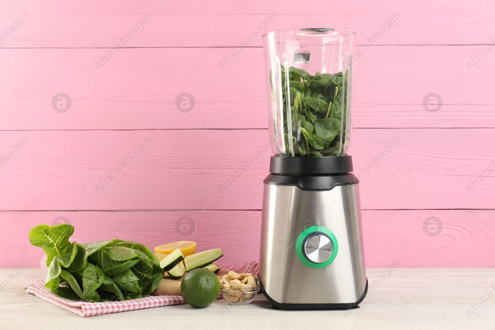 Photo of Modern blender with ingredients for smoothie on white wooden table. Space for text