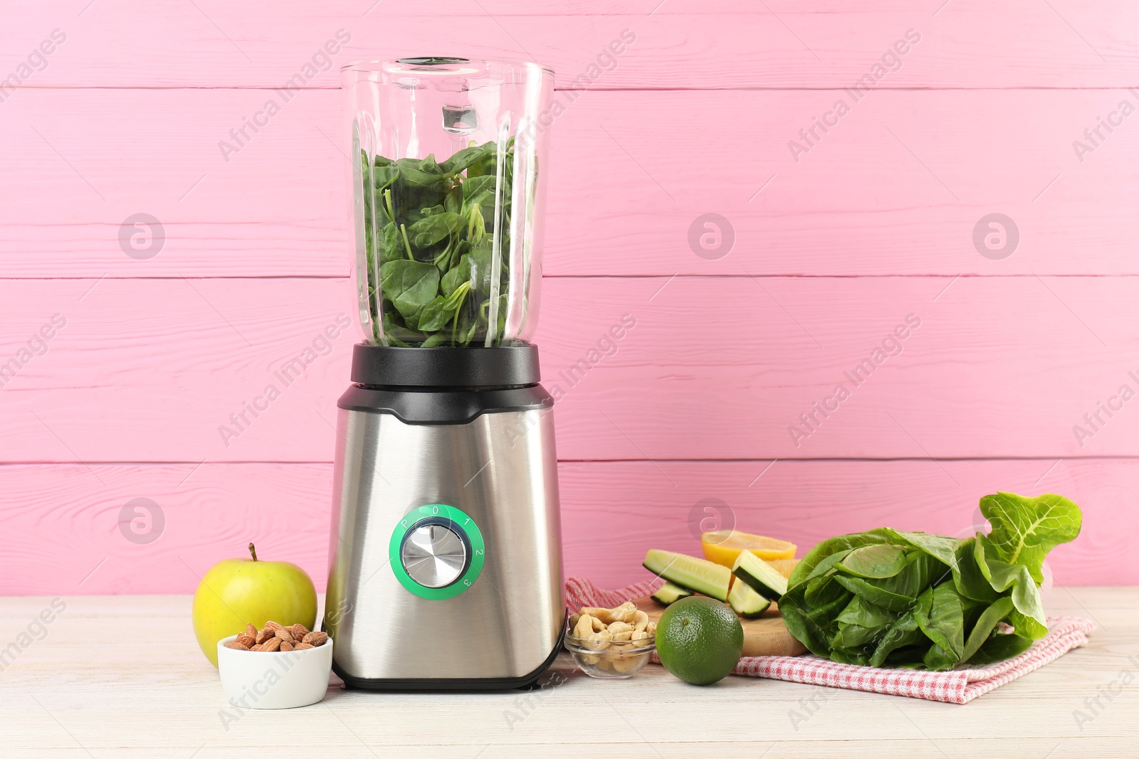 Photo of Modern blender with ingredients for smoothie on white wooden table. Space for text