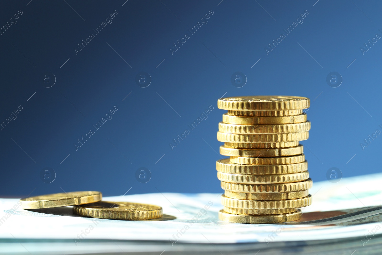 Photo of Stack of euro coins on blue background