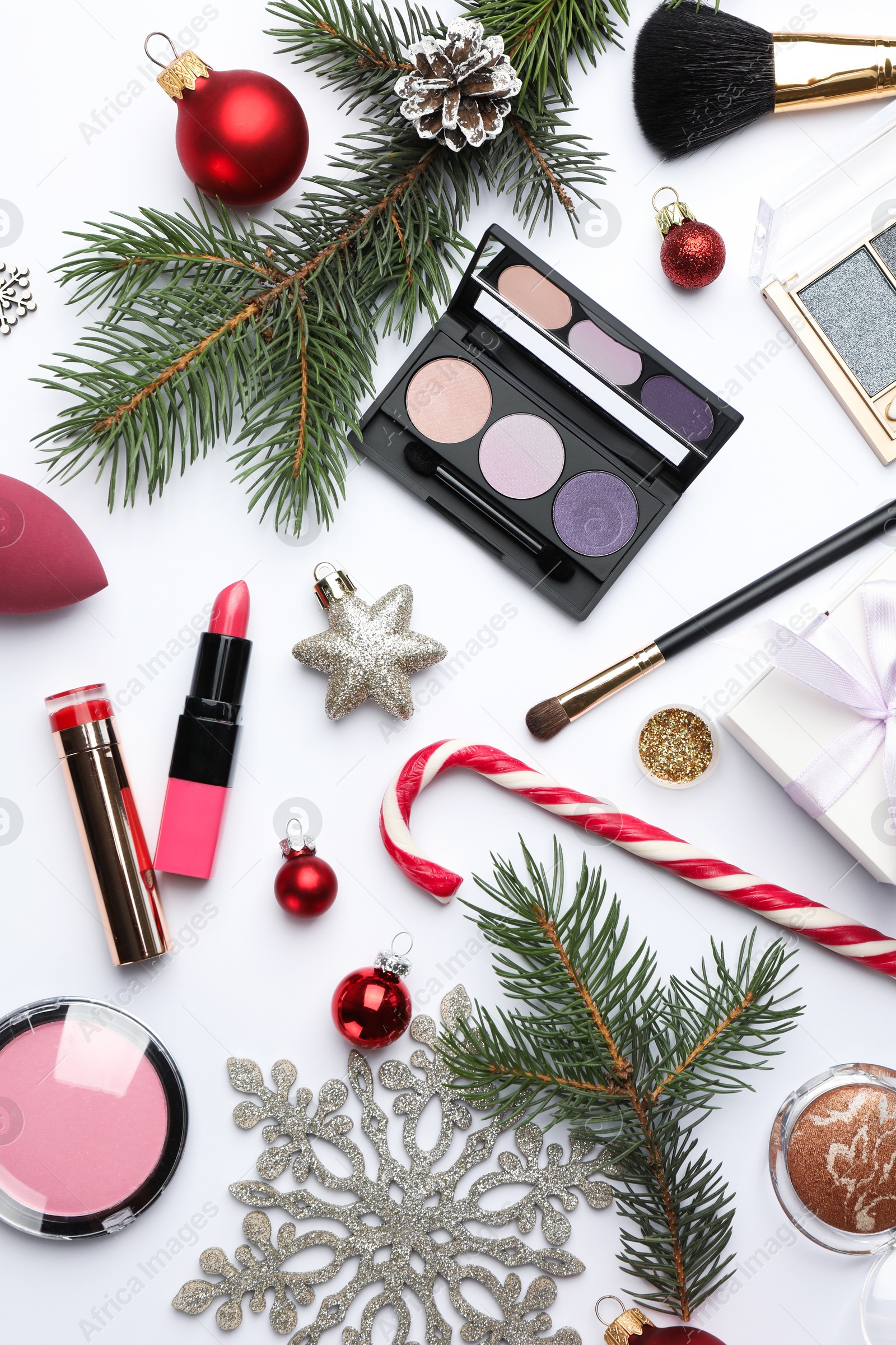 Photo of Different decorative cosmetic products and Christmas decor on white background, flat lay