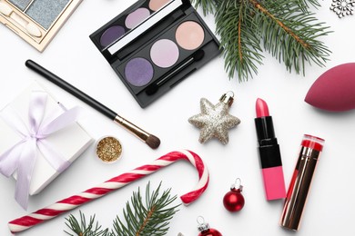 Photo of Different decorative cosmetic products and Christmas decor on white background, flat lay