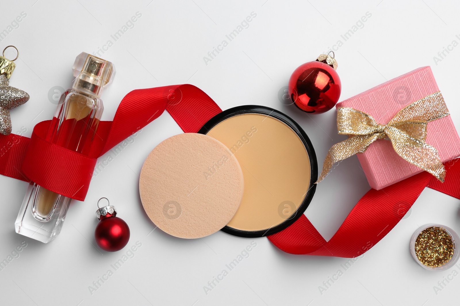 Photo of Different decorative cosmetic products and Christmas decor on white background, flat lay