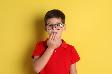 Photo of Portrait of cute little boy on yellow background