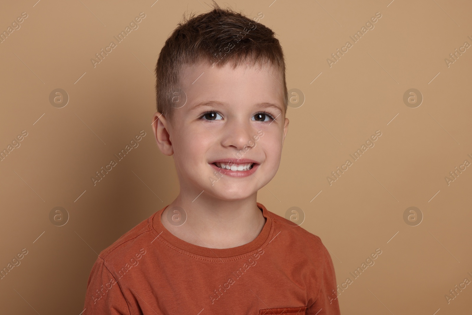 Photo of Portrait of cute little boy on pale background