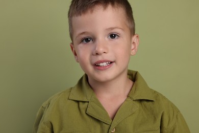 Photo of Portrait of cute little boy on green background