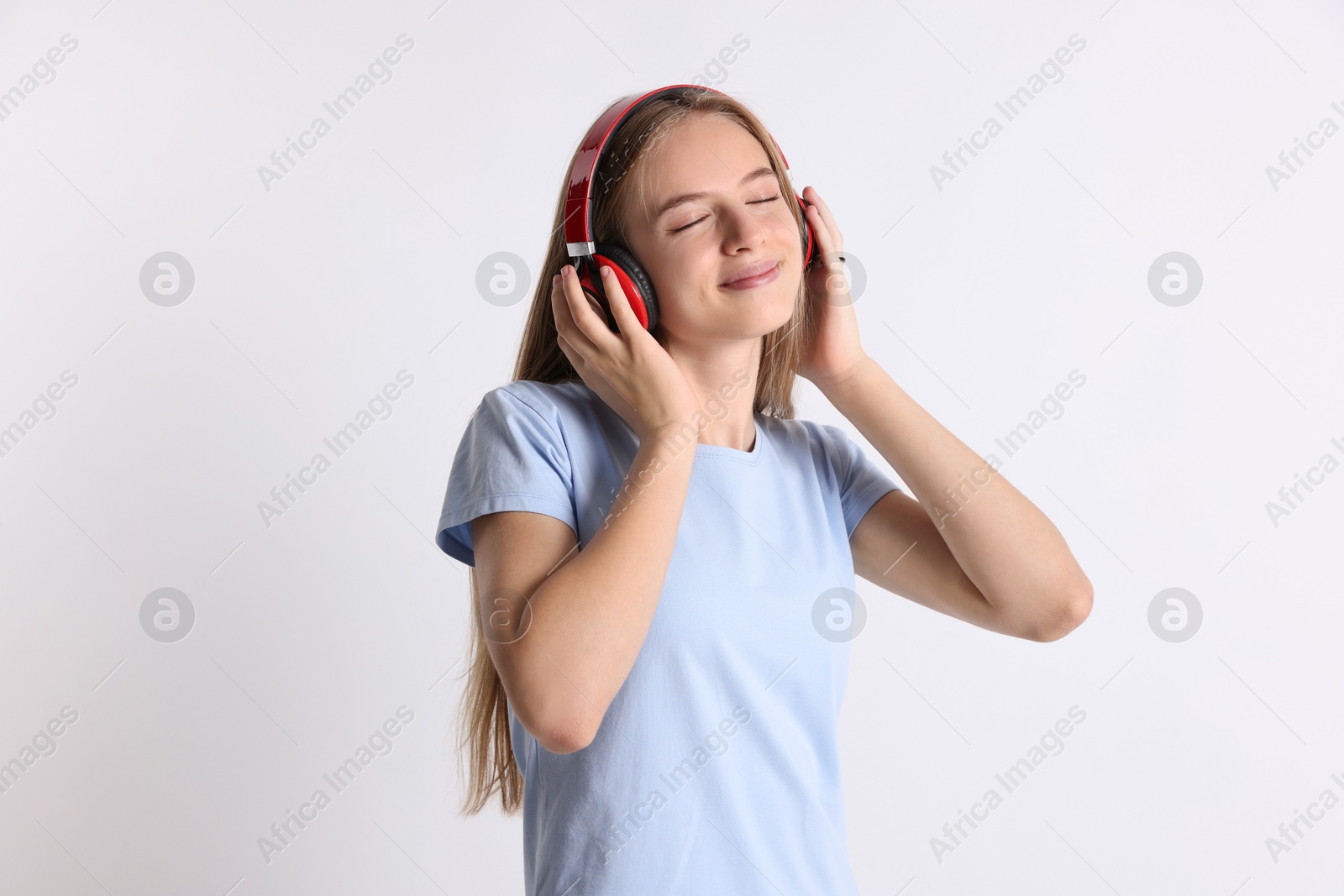 Photo of Teenage girl in headphones on white background