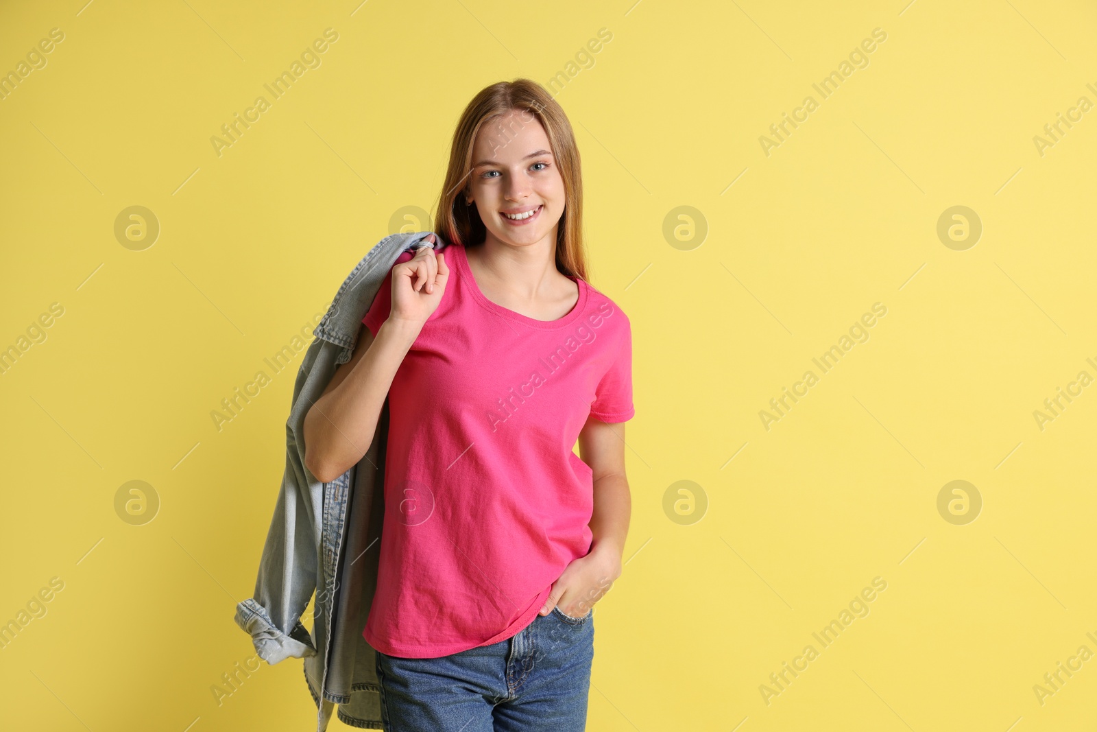 Photo of Teenage girl with denim jacket on yellow background