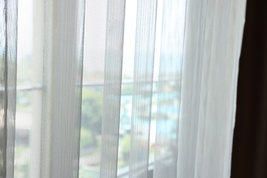 Window with light tulle in hotel room, closeup