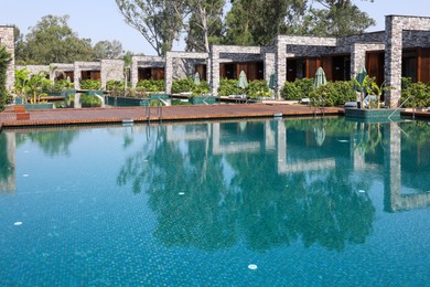 Photo of Outdoor swimming pool with clear water at luxury resort