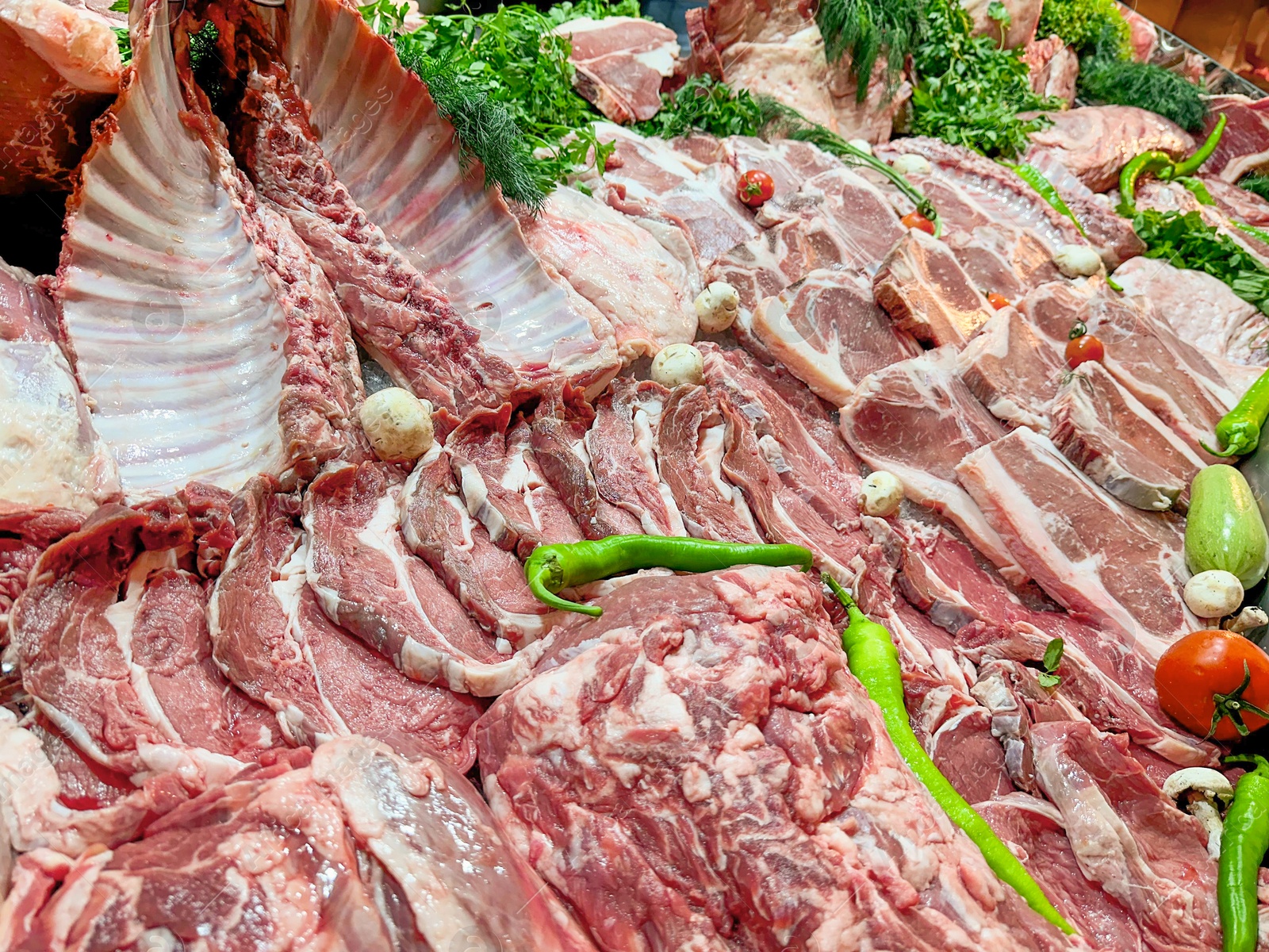 Photo of Closeup view of fresh cut raw meat and vegetables