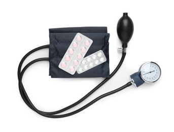 Blood pressure measuring device and pills in blisters isolated on white, top view