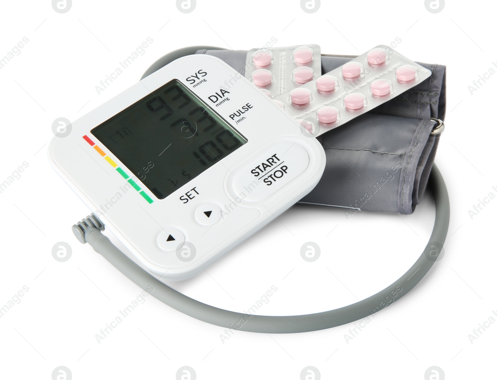 Photo of Blood pressure measuring device and pill blisters isolated on white