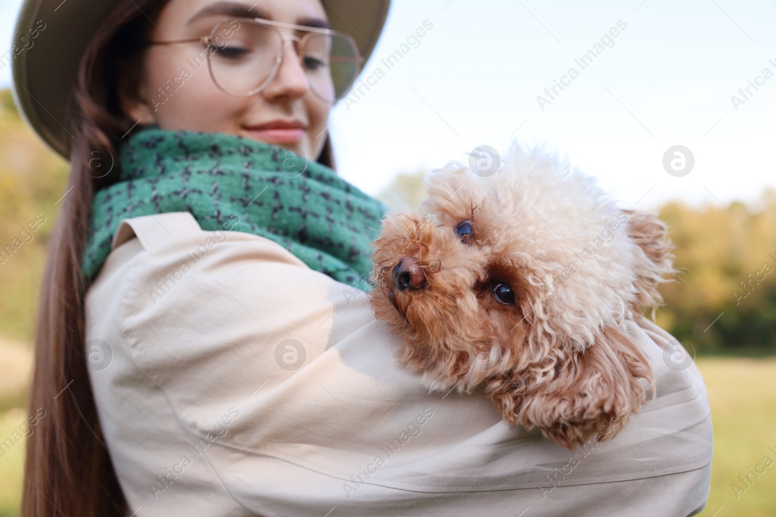 Photo of Portrait of woman with cute dog outdoors