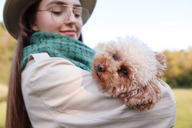 Photo of Portrait of woman with cute dog outdoors