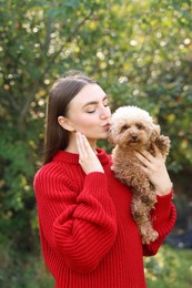 Portrait of woman with cute dog outdoors