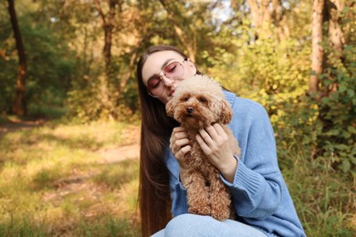 Woman with cute dog in autumn park. Space for text