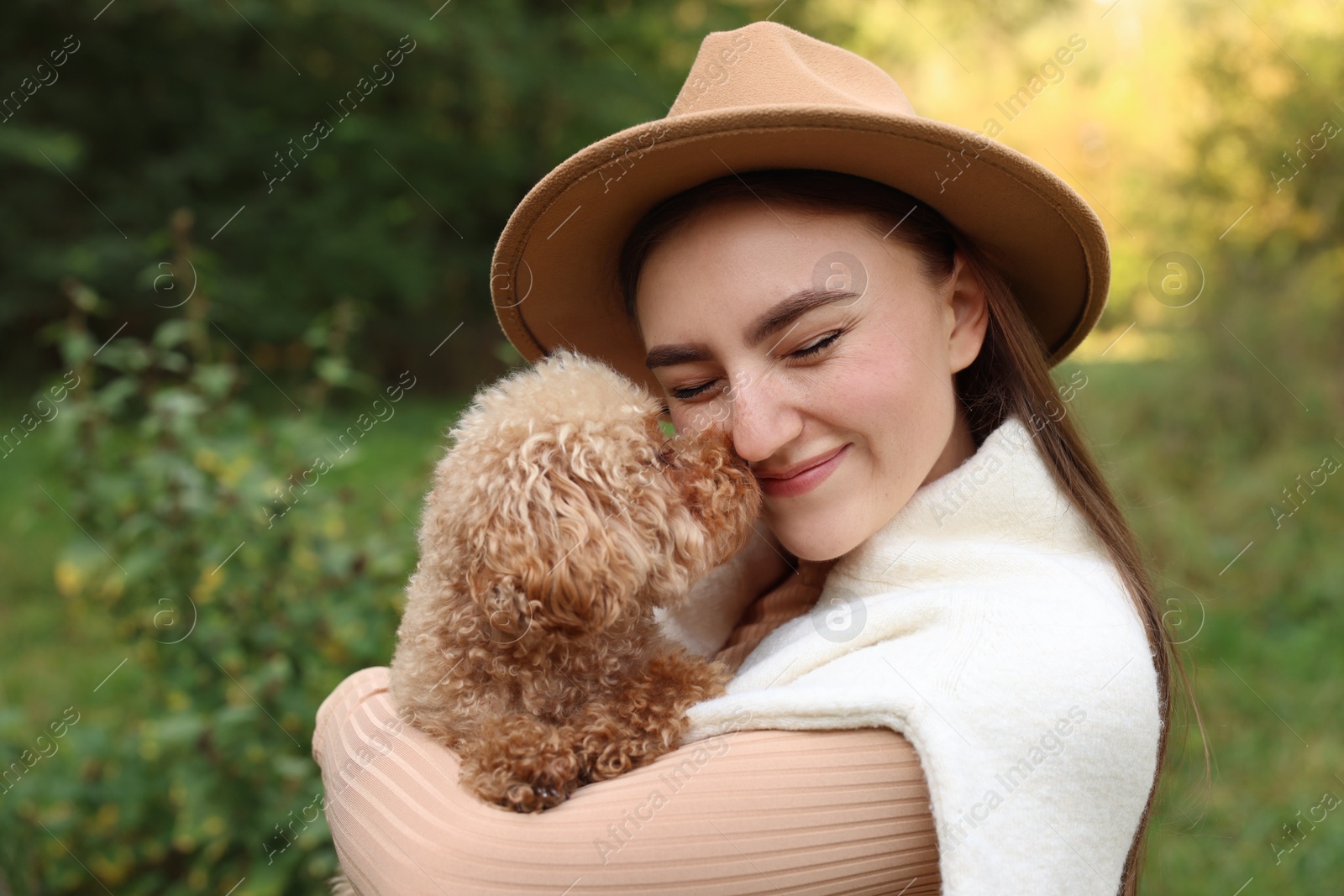 Photo of Portrait of woman with cute dog outdoors