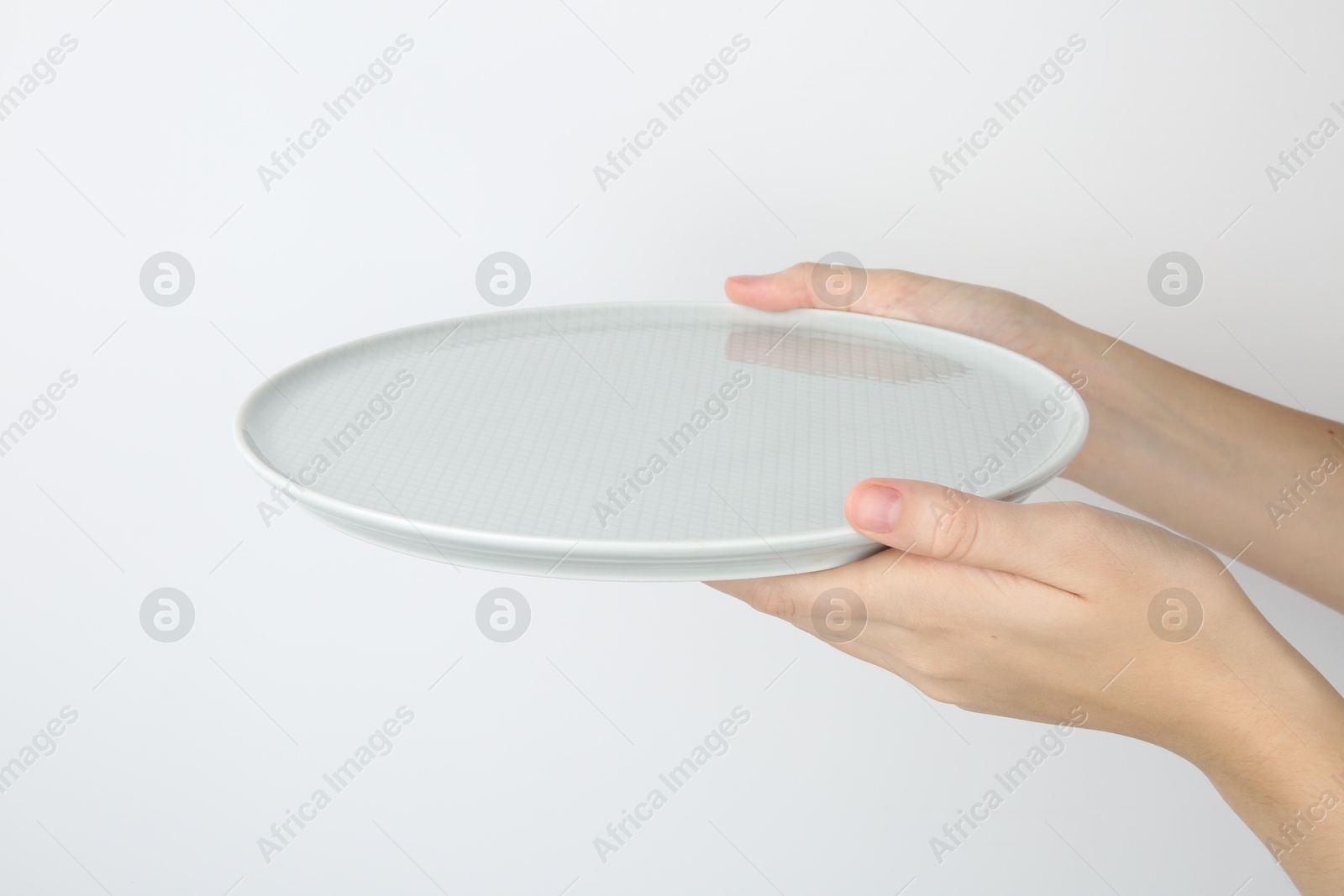 Photo of Woman with empty ceramic plate on white background, closeup