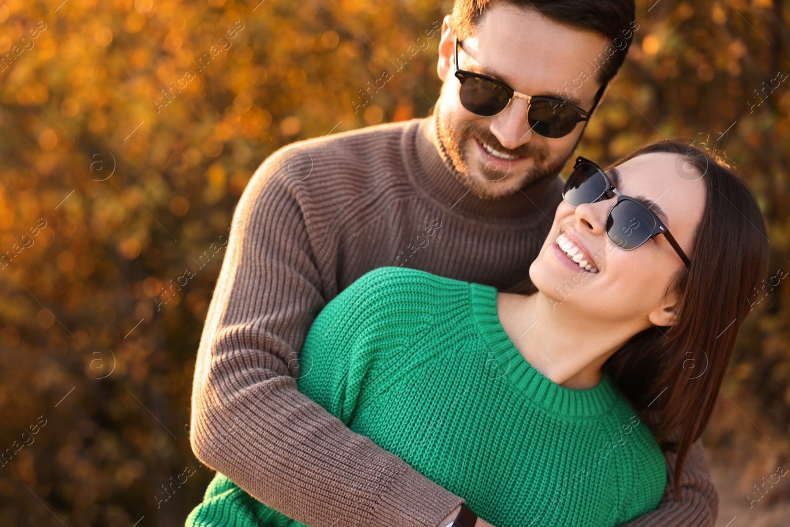 Photo of Beautiful happy couple hugging outdoors in autumn evening