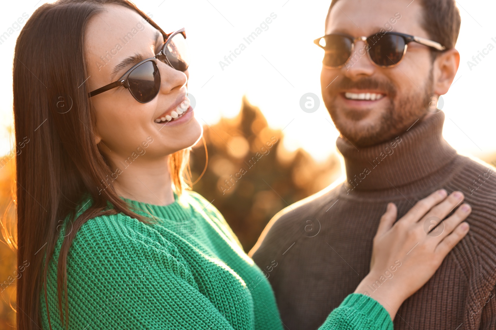 Photo of Beautiful couple spending time together outdoors in autumn evening, selective focus