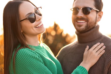 Photo of Beautiful couple spending time together outdoors in autumn evening, selective focus