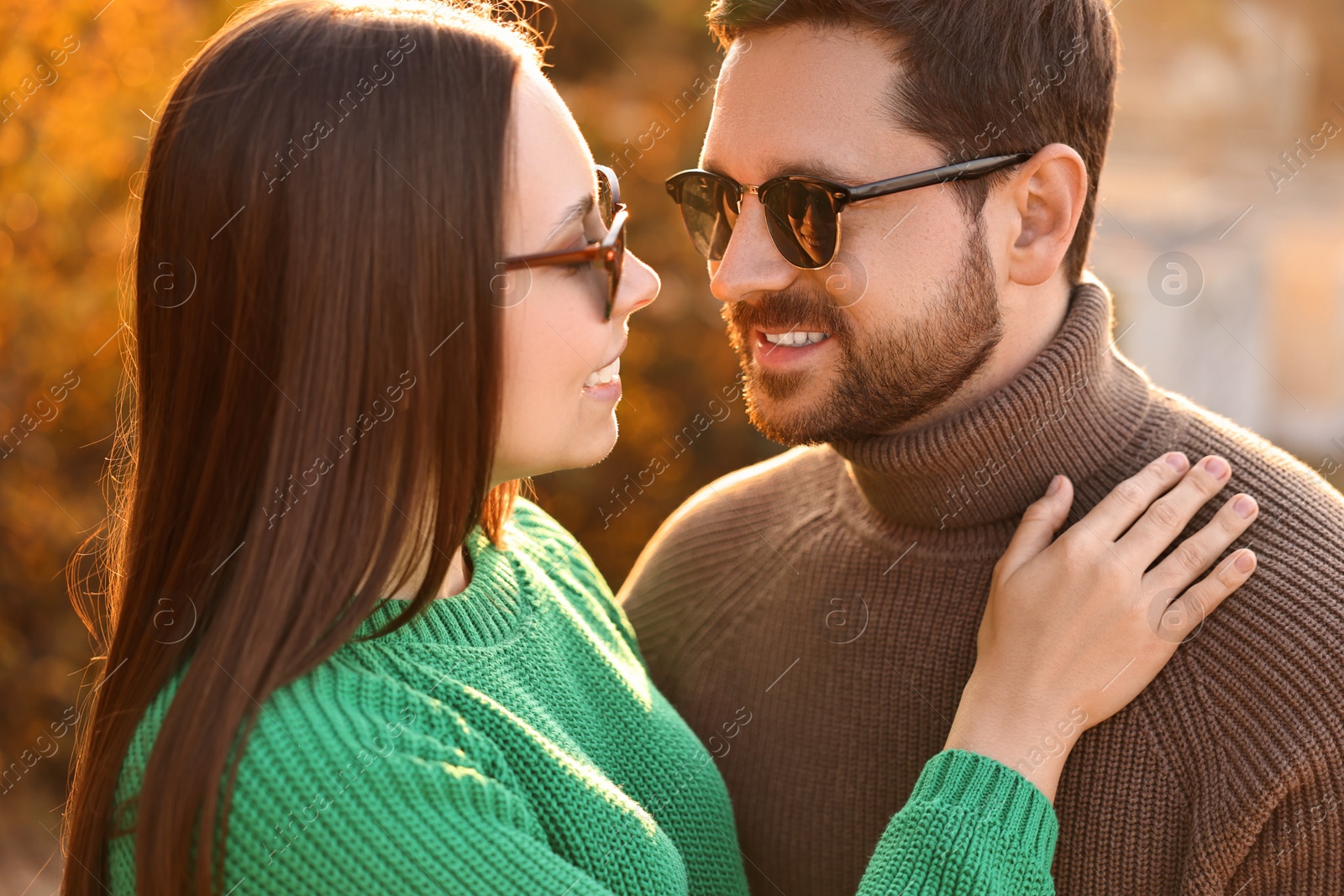 Photo of Beautiful couple enjoying their time together outdoors in autumn evening