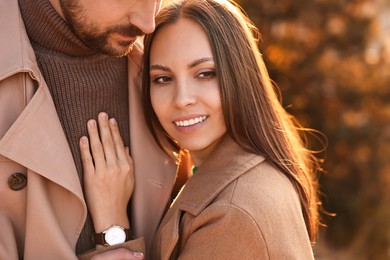 Beautiful couple hugging in autumn park, closeup