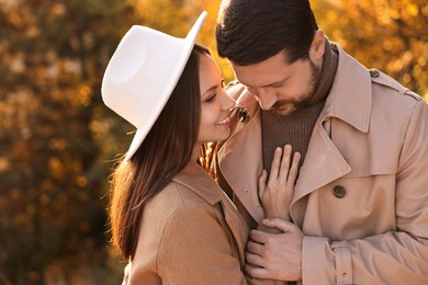 Beautiful couple spending time together in autumn park