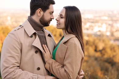 Beautiful couple spending time together outdoors on autumn day