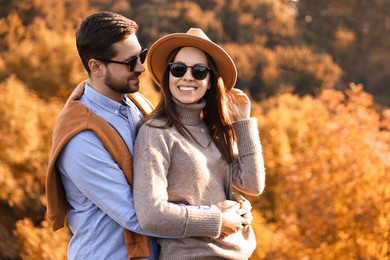 Photo of Beautiful happy couple in sunglasses outdoors on autumn day