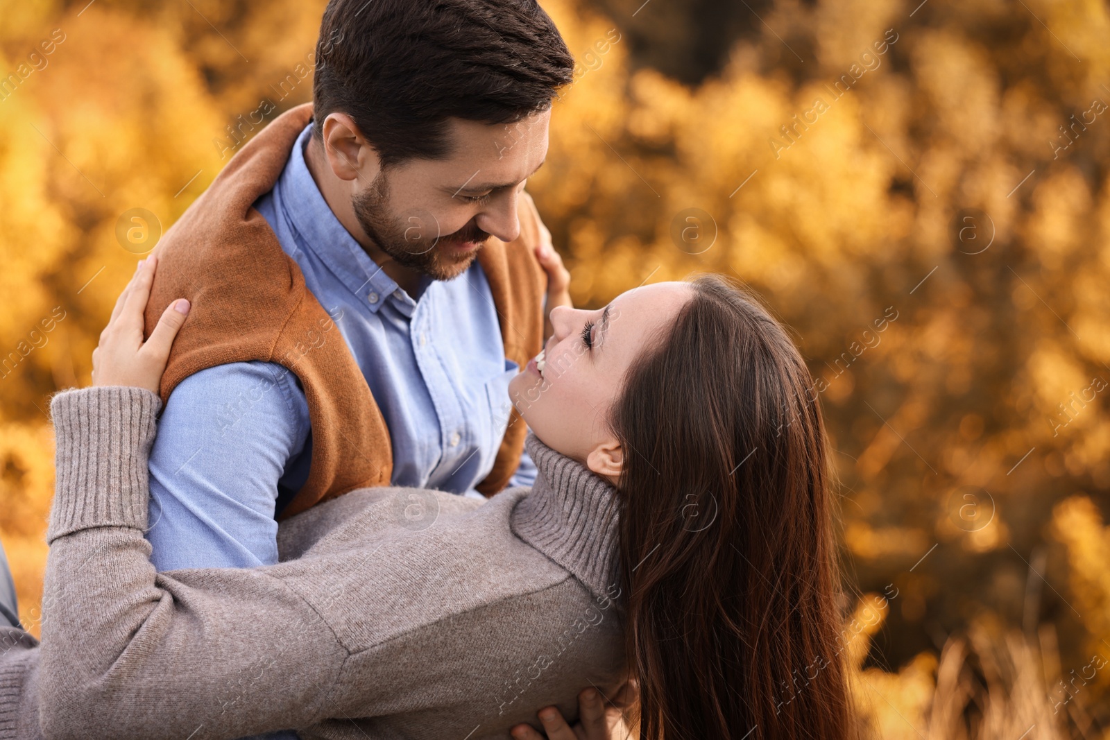 Photo of Beautiful couple spending time together outdoors on autumn day