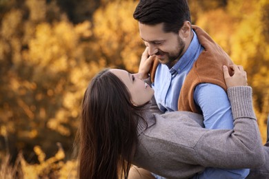 Beautiful couple spending time together outdoors on autumn day