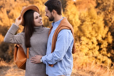 Beautiful couple spending time together outdoors on autumn day