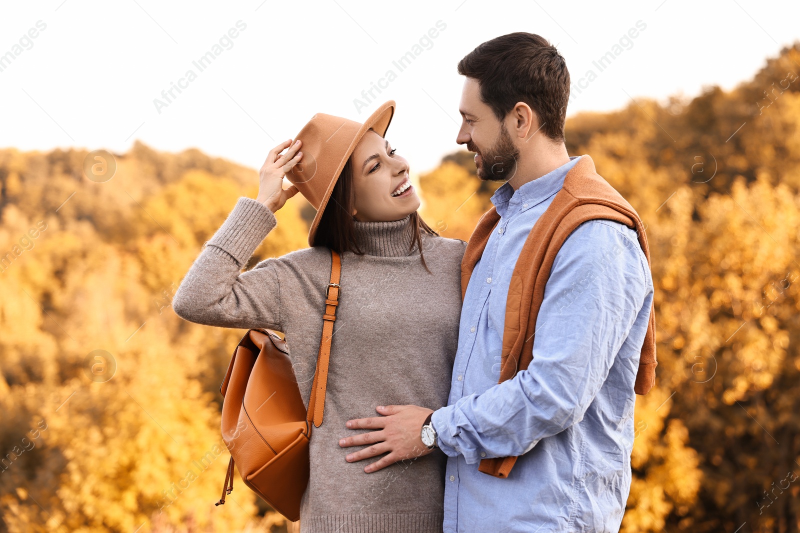 Photo of Beautiful couple spending time together outdoors on autumn day