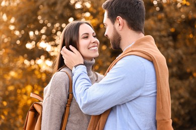 Beautiful couple spending time together outdoors on autumn day