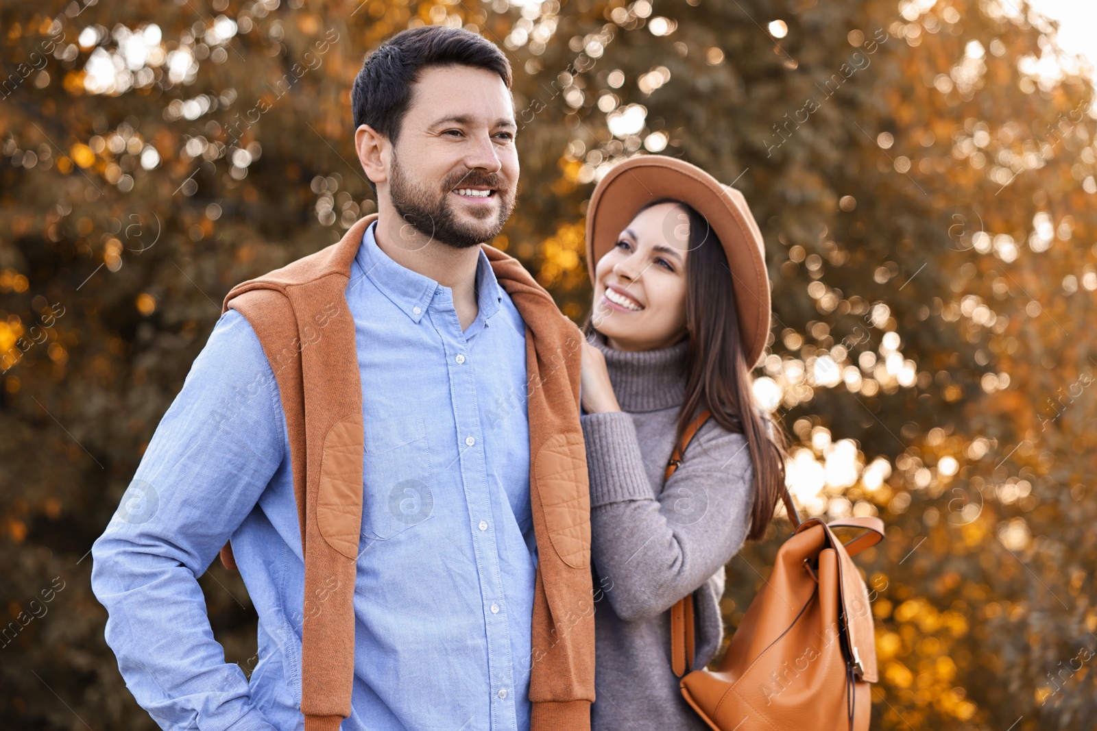 Photo of Beautiful couple spending time together in park on autumn day, selective focus