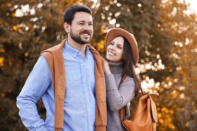 Photo of Beautiful couple spending time together in park on autumn day, selective focus