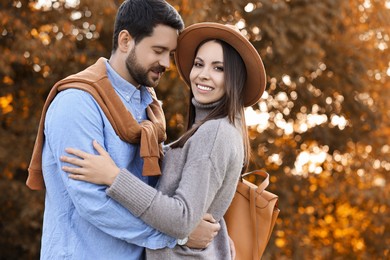 Beautiful couple spending time together outdoors on autumn day