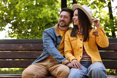 Beautiful couple spending time together in park on autumn day