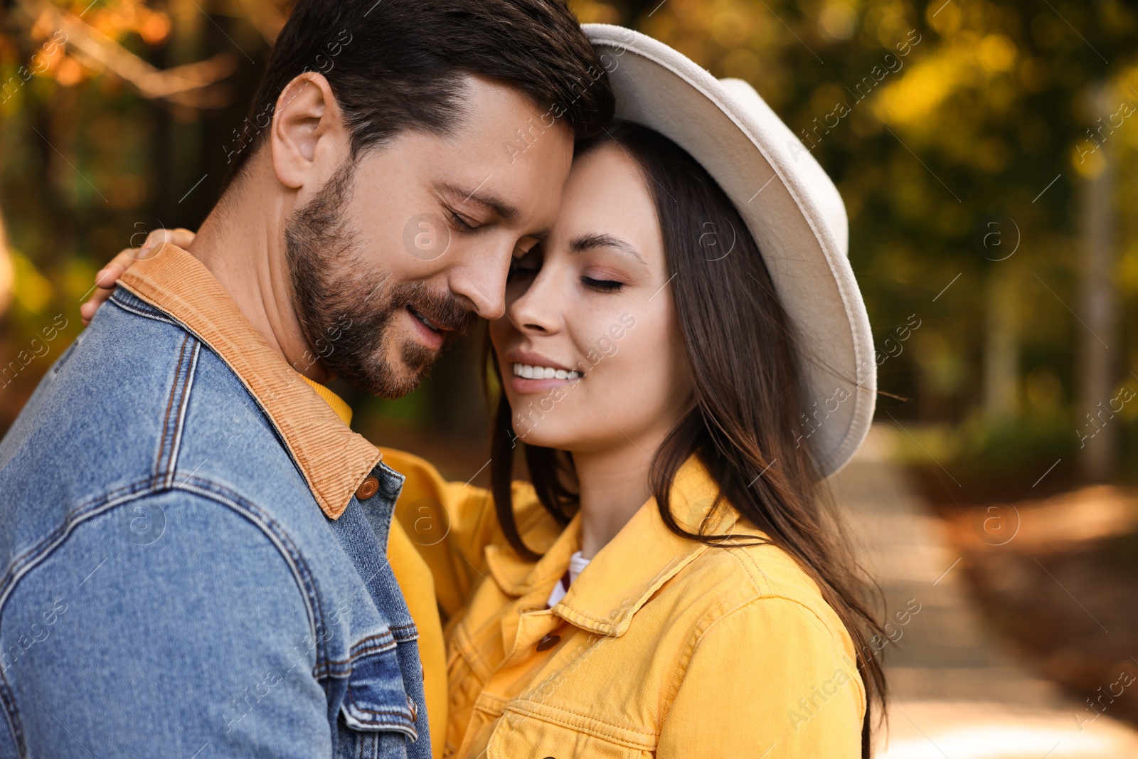 Photo of Beautiful couple enjoying their time together in autumn park