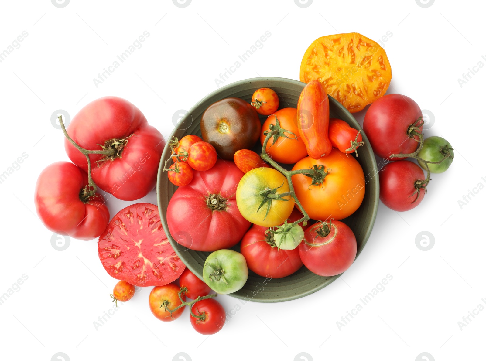 Photo of Different ripe tomatoes in bowl isolated on white, top view