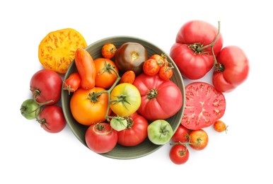 Photo of Different ripe tomatoes in bowl on white background, top view