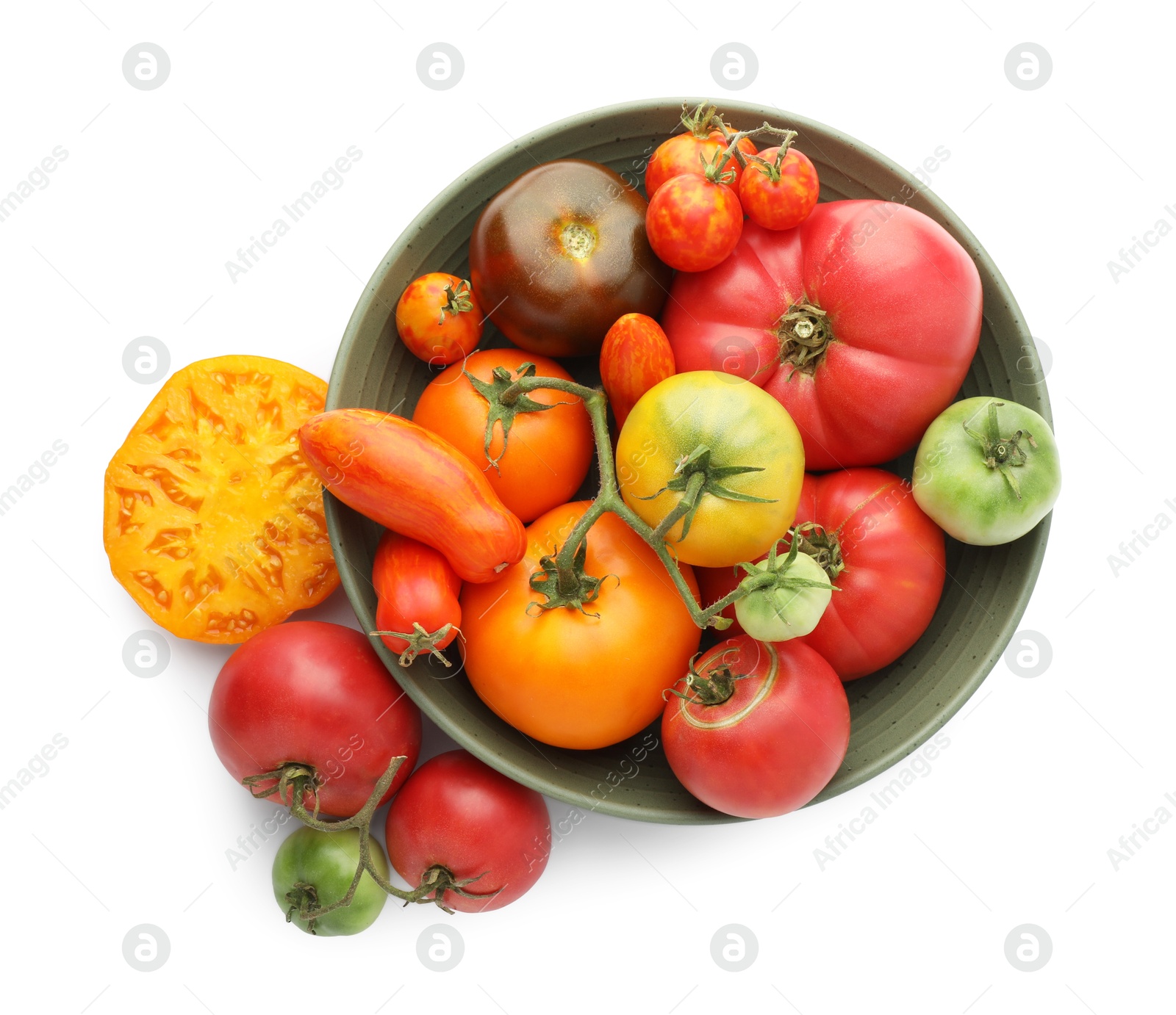 Photo of Different ripe tomatoes in bowl isolated on white, top view