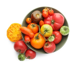 Different ripe tomatoes in bowl isolated on white, top view