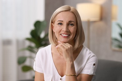 Photo of Portrait of smiling middle aged woman at home