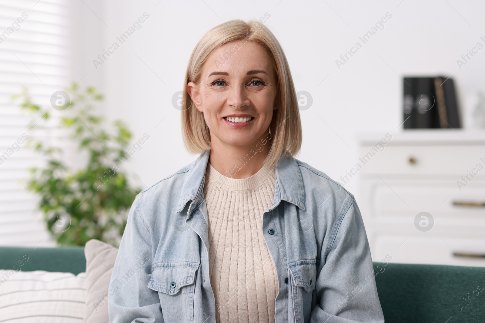 Photo of Portrait of smiling middle aged woman at home