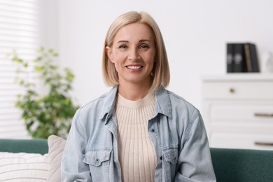 Portrait of smiling middle aged woman at home